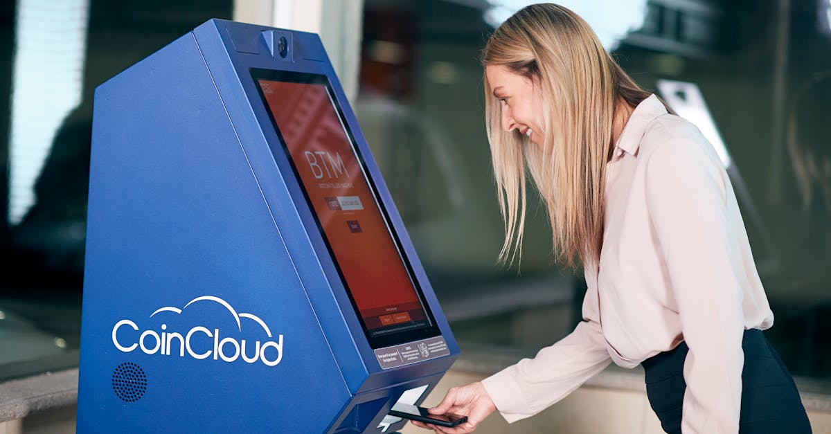 Woman smiling while using a CoinCloud cryptocurrency ATM indoors.