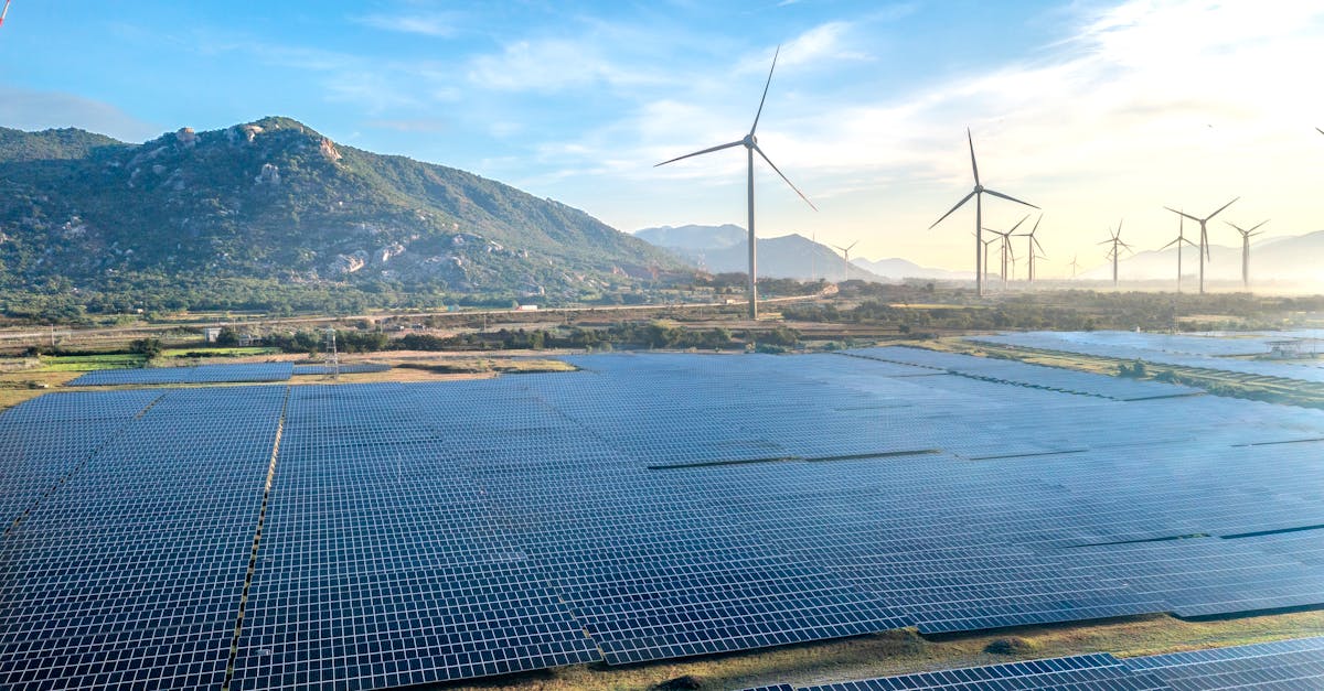 Aerial view of a solar and wind energy farm set against Vietnam's scenic landscape.