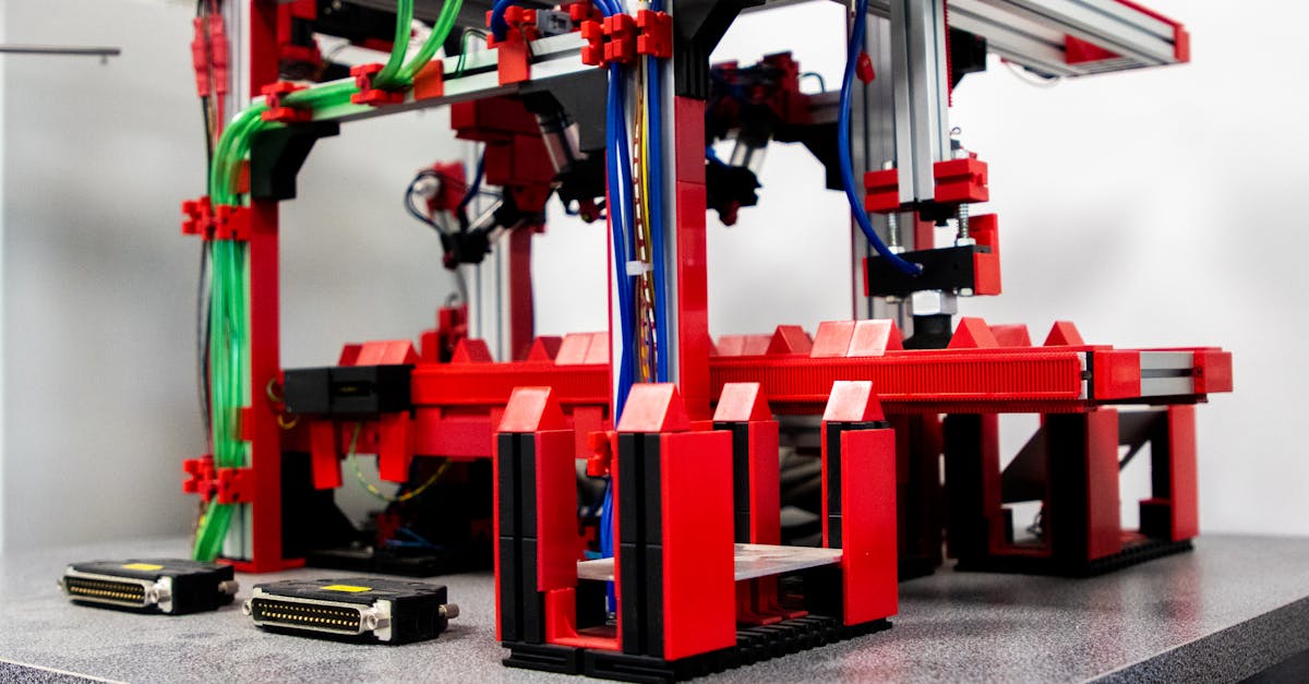 Close-up view of a robotic assembly machine with vibrant red and metallic components.
