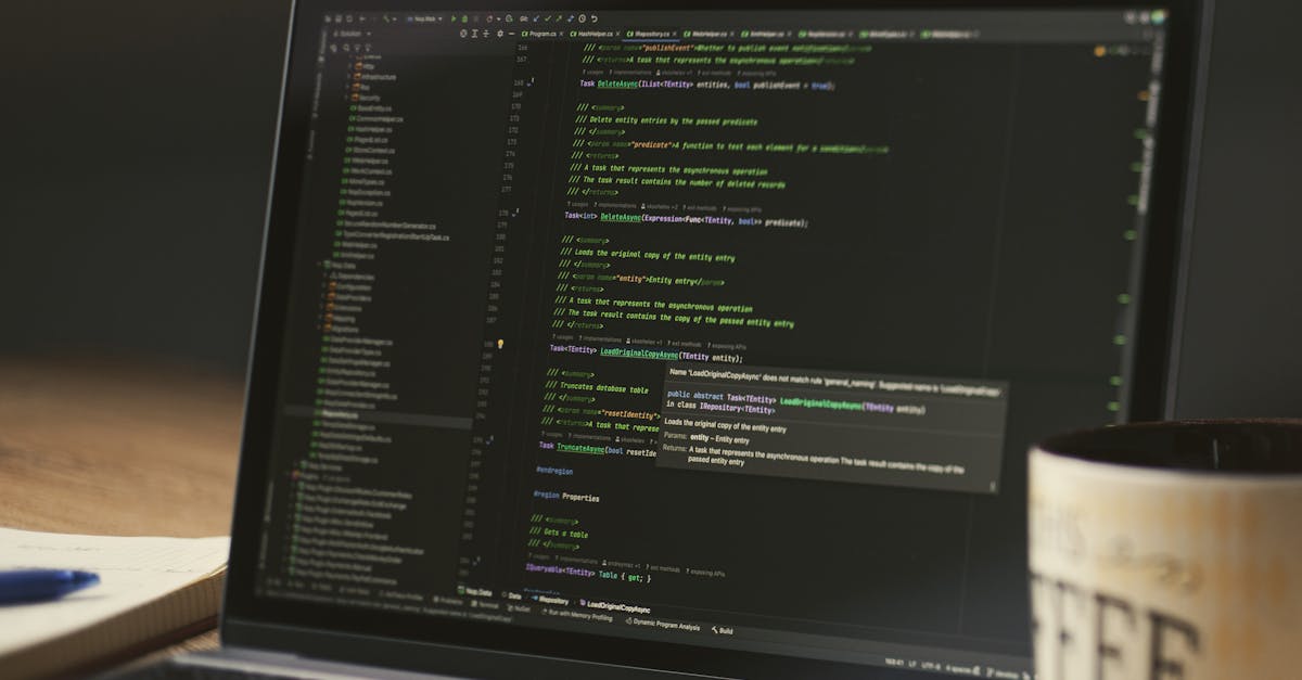 A close-up of a laptop displaying code in a dimly lit room with a coffee mug nearby.